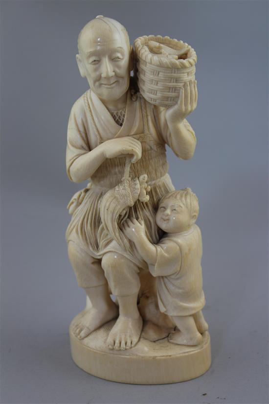 A Japanese ivory group of a fisherman and a boy, early 20th century, 13.5cm, age cracks